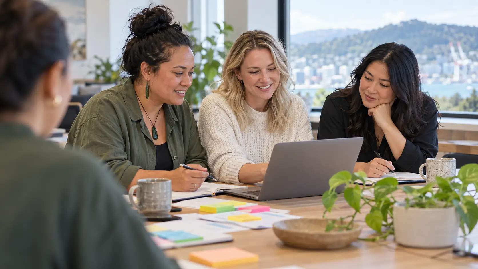 People discussing information around a laptop